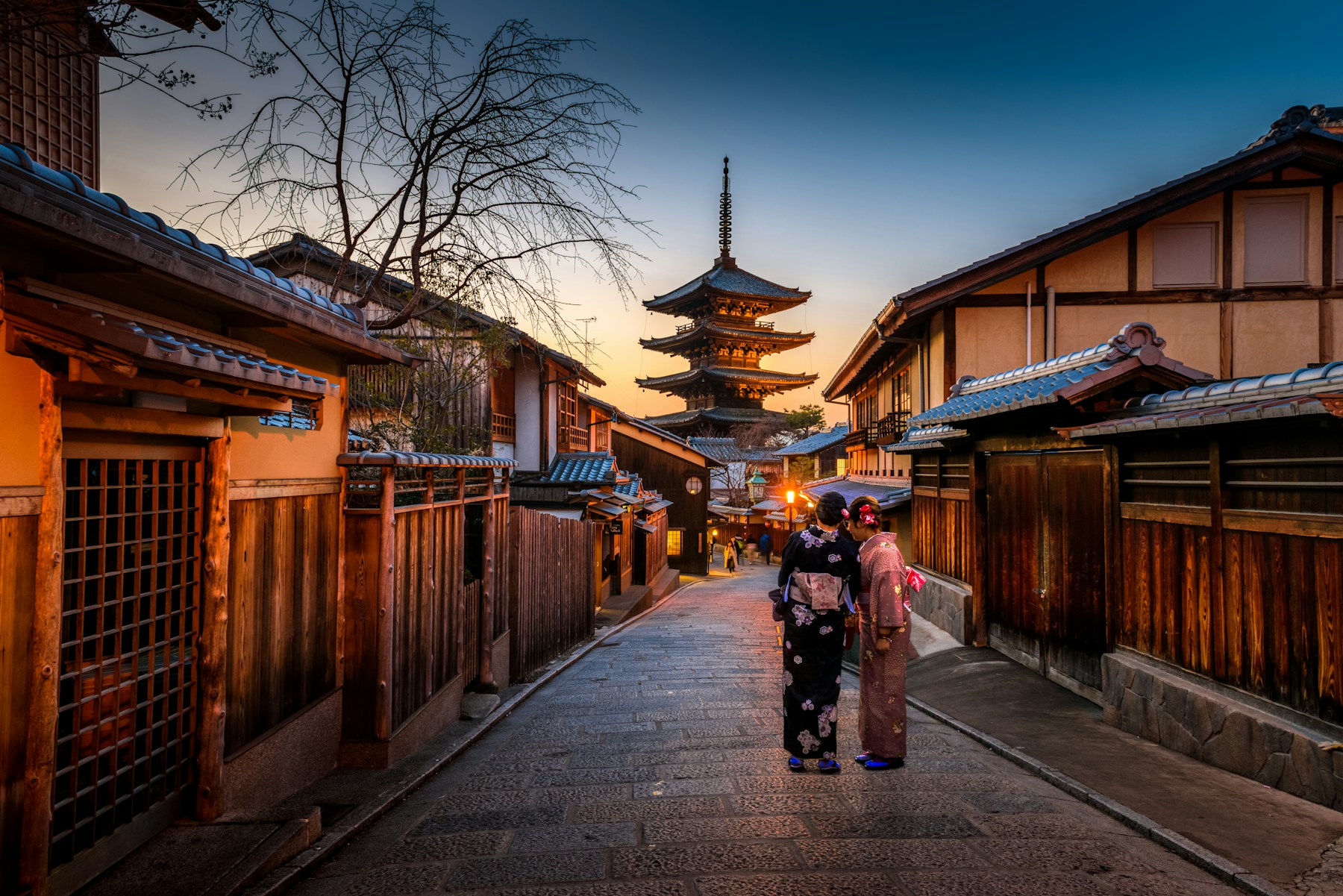 Traditional Japanese street and temple framed by mountains